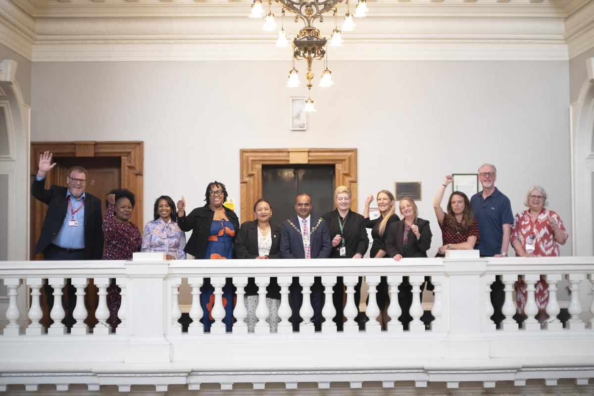 Greenwich Learns providers celebrating the rating on the balcony in the Town Hall