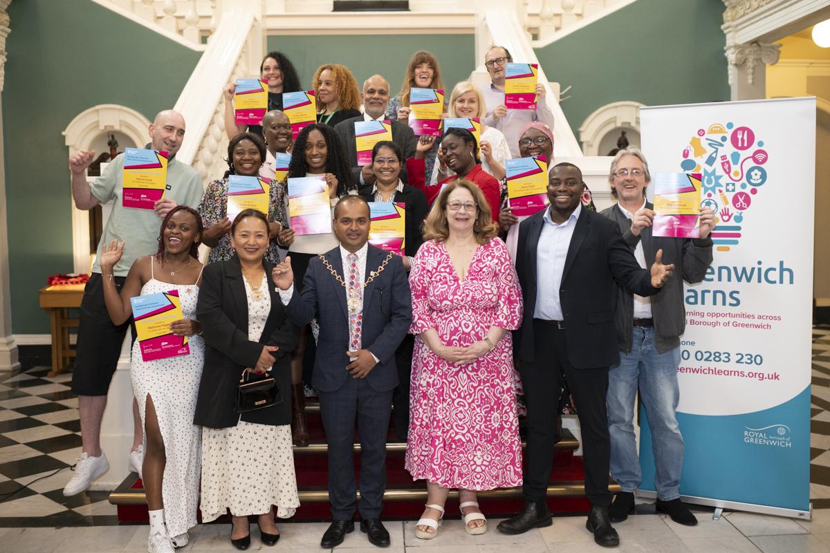 Photograph shows Cllr Anthony Okereke, Leader of the Royal Borough of Greenwich, with the Mayor - Cllr Jit Ranabhat - with a group of people celebrating the Adult Community Learning Awards inside the Woolwich Town Hall