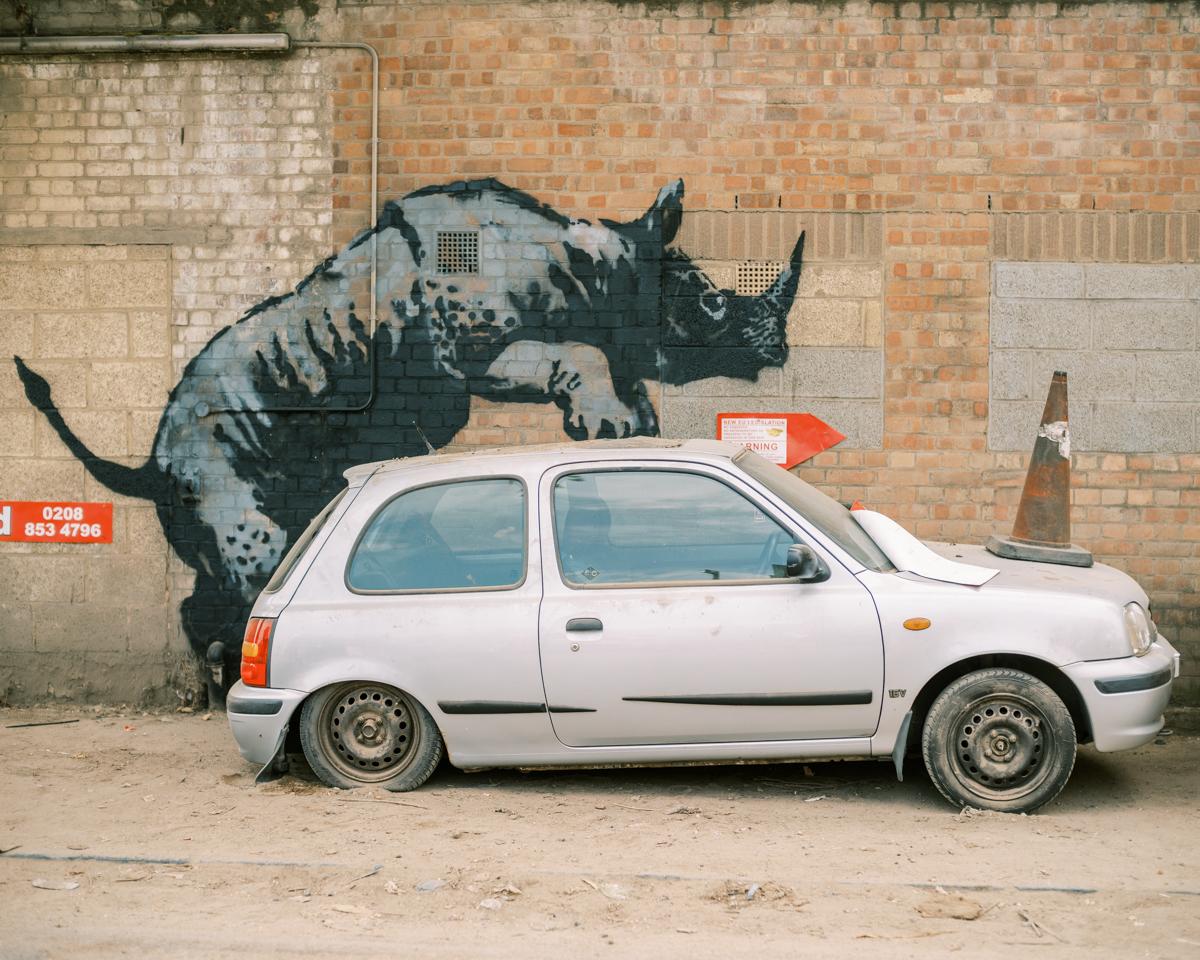 Banksy artwork in Charlton, depicting a rhino climbing on a silver car