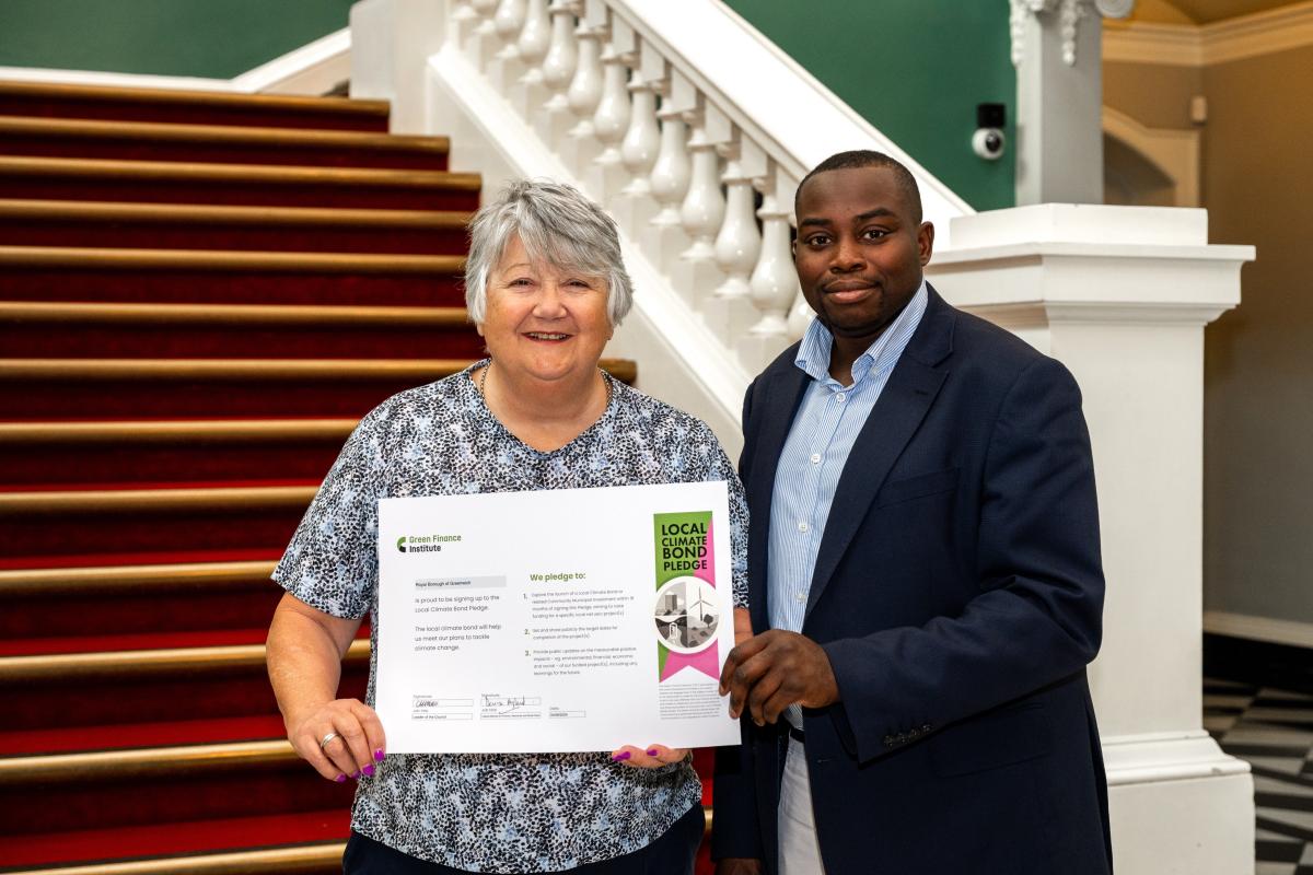 Cllr Anthony Okereke and Cllr Denise Hyland holding the signed Greenwich Green Investment pledge