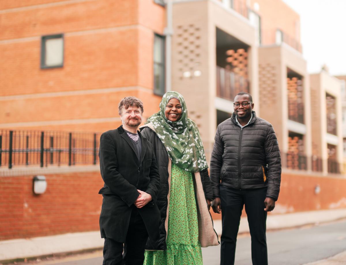 Cllr Anthony Okereke and Cllr Aidan Smith with a tenant outside new council homes at Bliss Crescent.