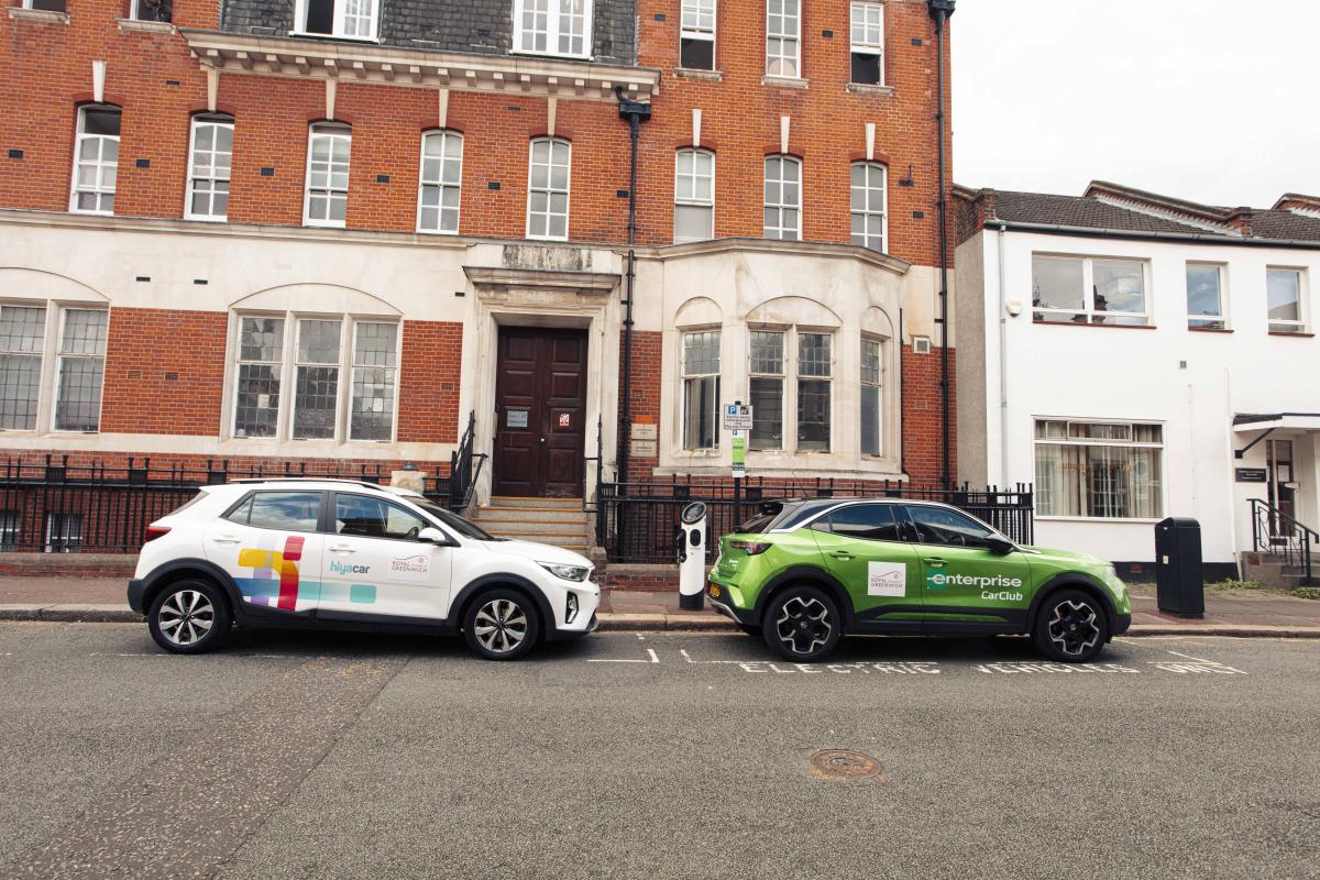 Two branded car clubs parked by the side of the road