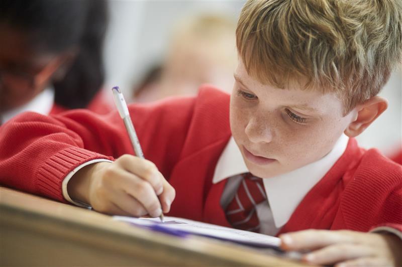 Child writing at school