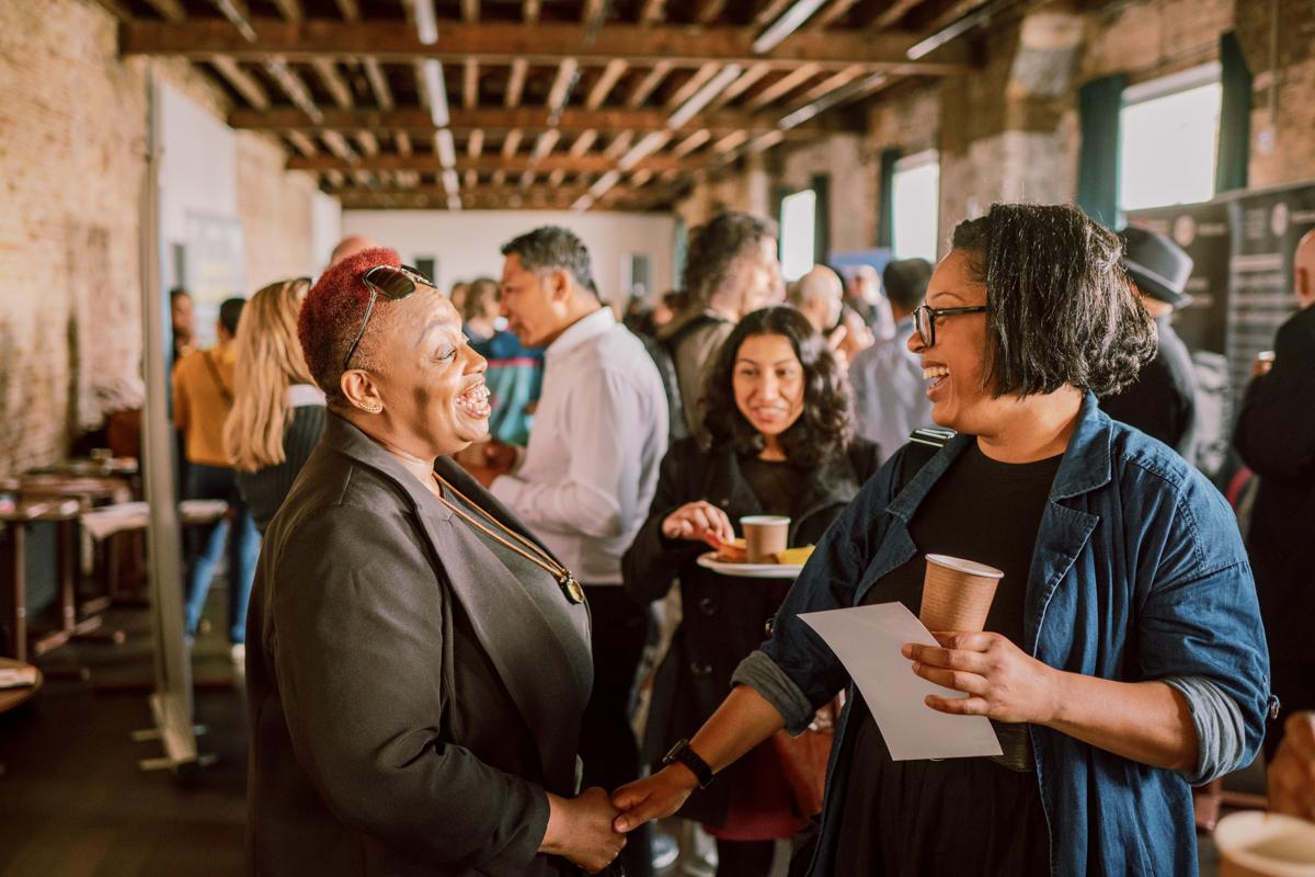 Some people making connections at a business breakfast networking event.