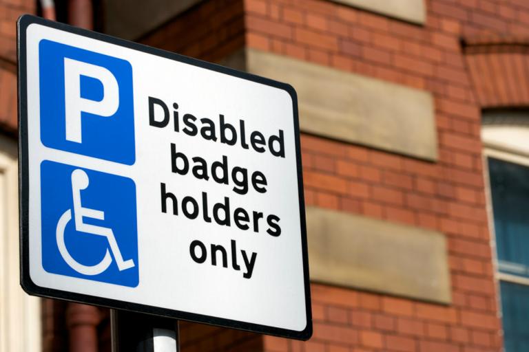 'Disabled blue badge holders only' parking sign