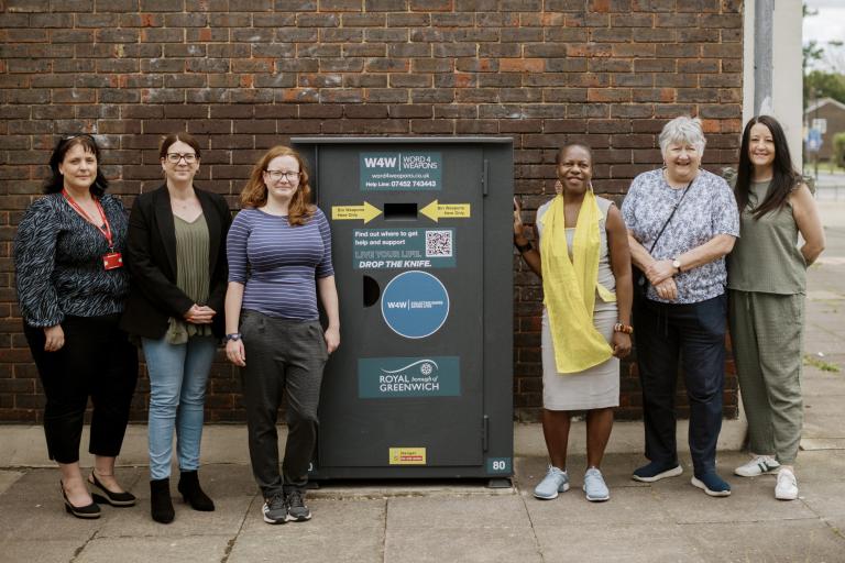 A photo of councillors and staff members standing next to the knife amnesty bin in Abbey Wood