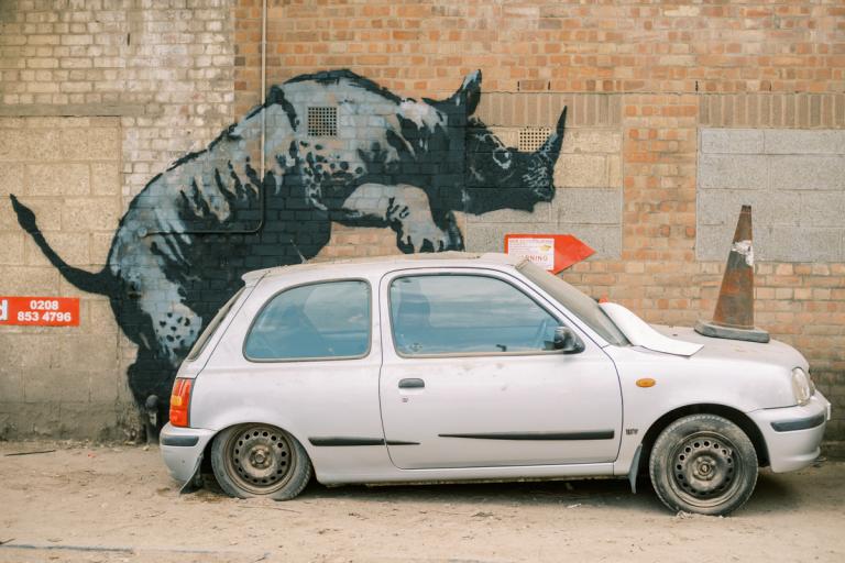 Banksy artwork in Charlton, depicting a rhino climbing on a silver car