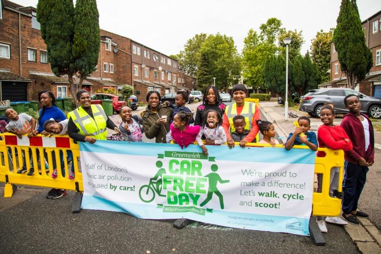 group of residents with a Car Free Day banner.