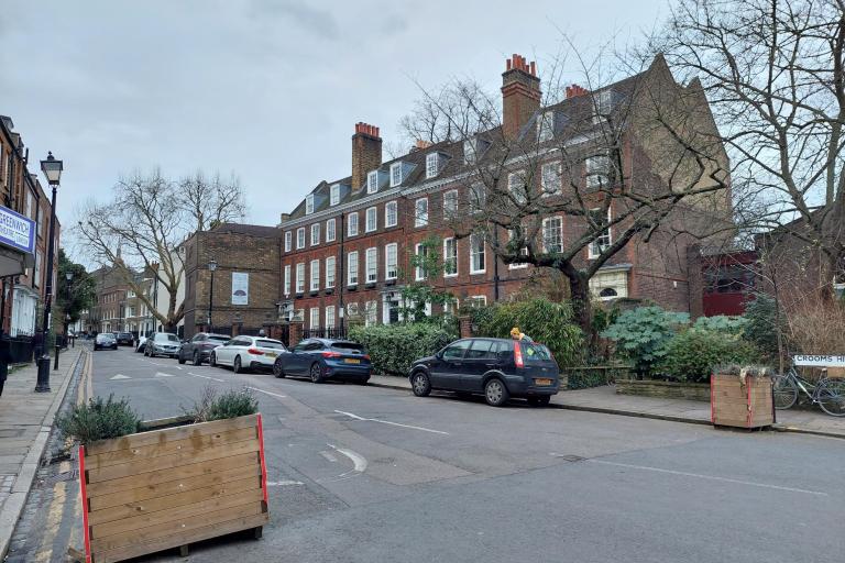 street view of parked cars on road 